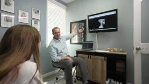 Dr. Jon Guymon explaining patient x-rays during consultation at Gateway To Wellness Cedar Park