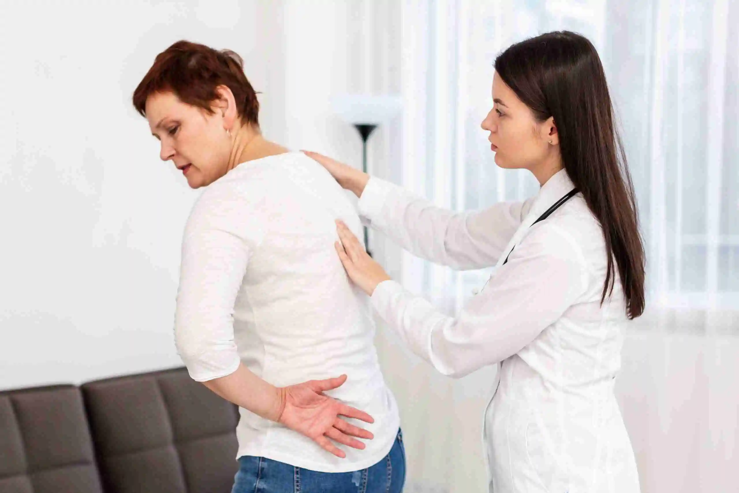 Chiropractor helping woman with her chronic pain