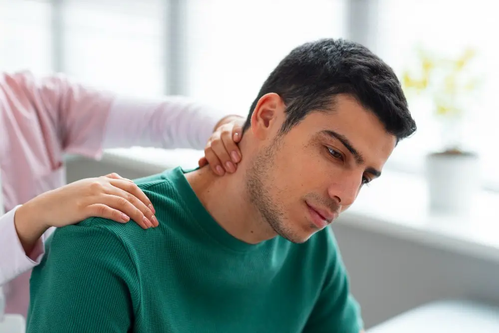 Doctor helping patient with neck pain