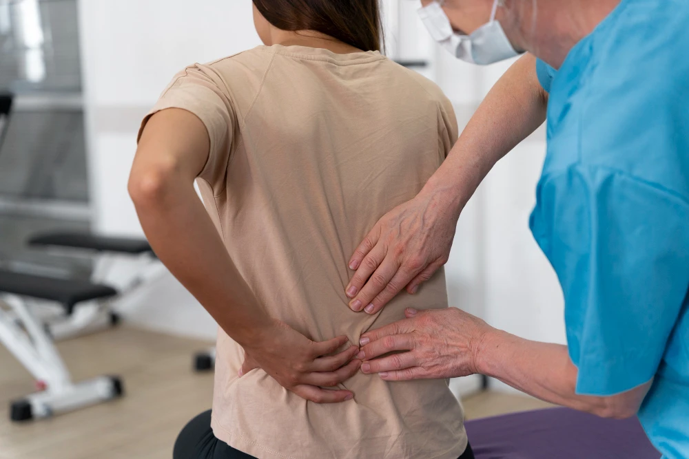 Person experiencing lower back pain from herniated disc