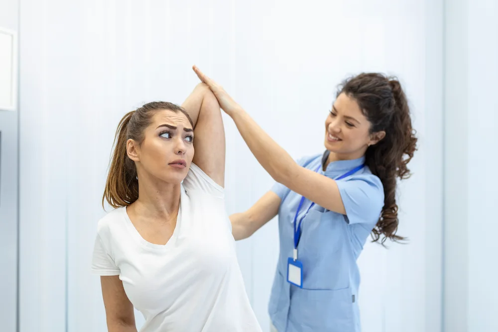 Chiropractor discussing treatment plan and recovery timeline with patient during consultation