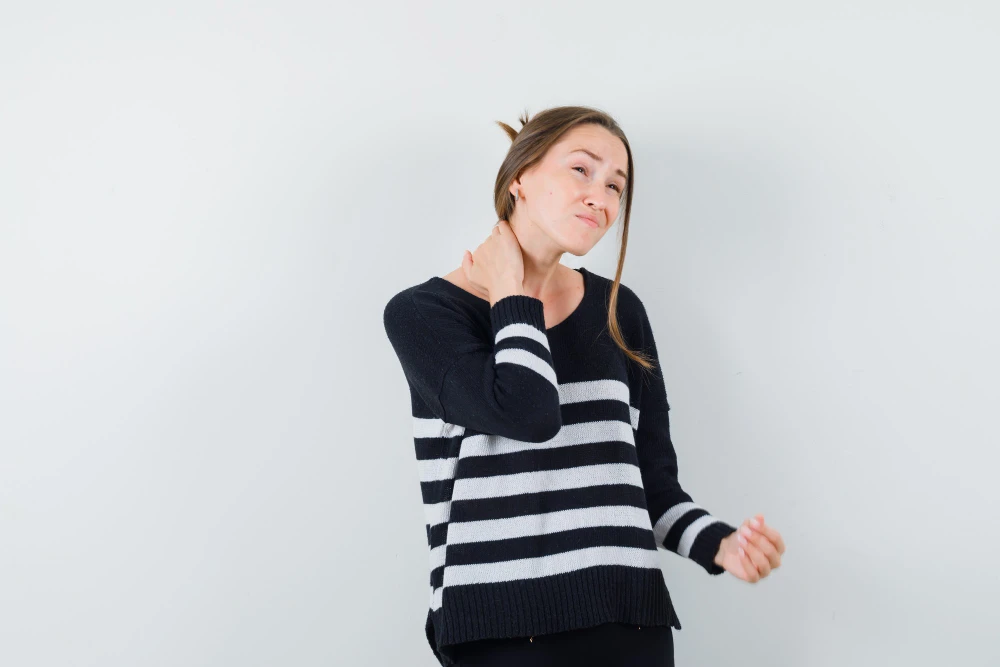 Person waking up with neck pain after poor sleep posture
