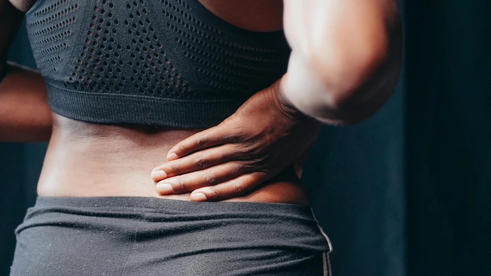 Woman experiencing one-sided lower back pain and discomfort