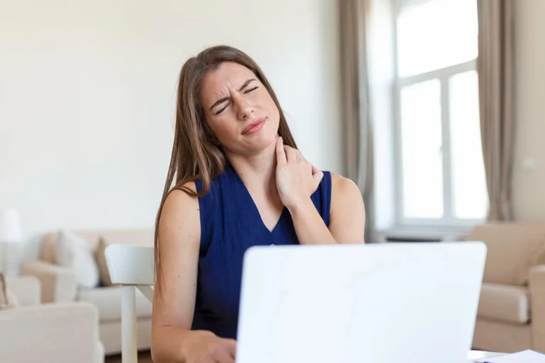 Woman with neck pain from delayed whiplash injury