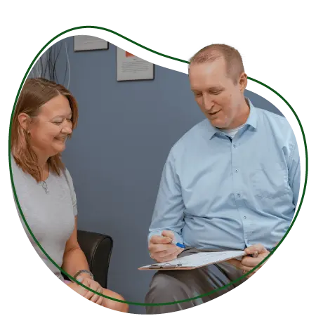 Chiropractor consulting with a patient in a clinic