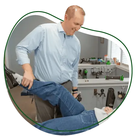 Chiropractor performing leg adjustment on a patient