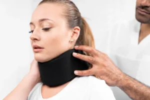 Patient receiving treatment for whiplash injury to reduce neck pain and restore movement