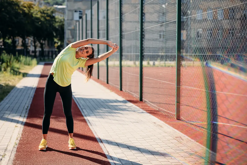 Pickleball player warming up with stretches before a game