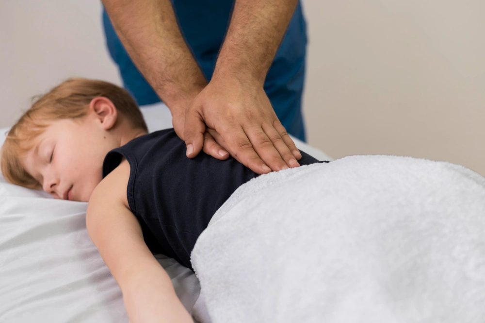 Chiropractor performing gentle adjustment on child patient