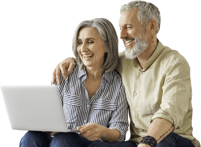 Older couple smiling at computer