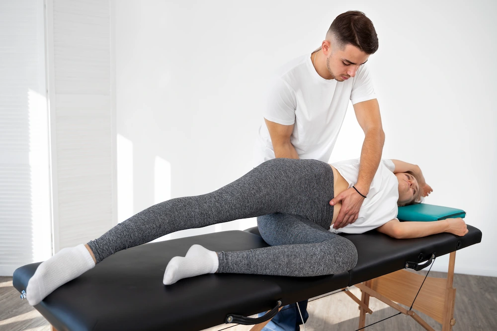 Chiropractor performing spinal adjustment to improve alignment and relieve back pain