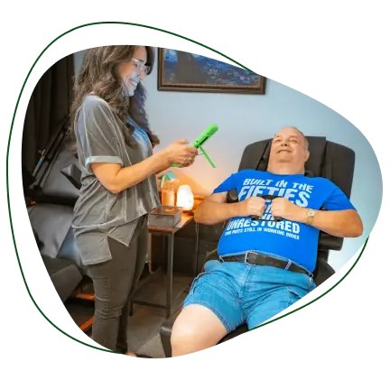 Chiropractor performing muscle response testing on a patient